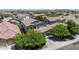 Aerial view of a well-maintained home in a suburban neighborhood, framed by mature trees and landscaping at 10430 W Los Gatos Dr, Peoria, AZ 85383