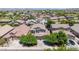 Scenic aerial shot shows the neighborhood with mountain views, mature trees, and well-maintained lawns at 10430 W Los Gatos Dr, Peoria, AZ 85383