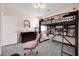This cozy bedroom includes a lofted bed, a closet, and a comfortable desk area in a well-lit space at 10430 W Los Gatos Dr, Peoria, AZ 85383