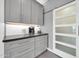 Stylish butler's pantry with gray cabinets, a gray countertop, and a convenient sliding barn door entrance at 10430 W Los Gatos Dr, Peoria, AZ 85383