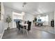 Dining room with a modern glass table and a billiards area illuminated by stylish lights at 10430 W Los Gatos Dr, Peoria, AZ 85383
