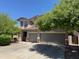 Charming two-story home featuring a three-car garage and mature landscaping at 10430 W Los Gatos Dr, Peoria, AZ 85383