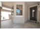 Cozy front porch featuring stucco walls, large window, and a decorative front door with a welcome mat at 10430 W Los Gatos Dr, Peoria, AZ 85383