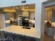 Modern kitchen featuring a large island with a white countertop and gray cabinets and stainless steel appliances at 10430 W Los Gatos Dr, Peoria, AZ 85383