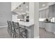 Open kitchen with sleek countertops, modern cabinetry, and an island with barstool seating for casual dining at 10430 W Los Gatos Dr, Peoria, AZ 85383