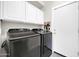 Convenient laundry room equipped with modern washer, dryer, and ample storage space at 10430 W Los Gatos Dr, Peoria, AZ 85383