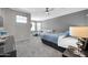 This main bedroom features a ceiling fan, wall-mounted TV, and a comfortable sitting area for relaxing and unwinding at 10430 W Los Gatos Dr, Peoria, AZ 85383