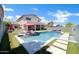 Backyard pool area featuring lounge chairs and an outdoor dining space under a covered patio at 10430 W Los Gatos Dr, Peoria, AZ 85383