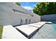 Stunning pool with a decorative waterfall feature set into a modern block wall and stone walkways at 10430 W Los Gatos Dr, Peoria, AZ 85383