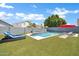 Inviting backyard with a pristine pool, artificial turf, lounge chairs and privacy fencing, perfect for summer days at 10430 W Los Gatos Dr, Peoria, AZ 85383