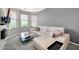 The cozy sitting area includes a sectional couch, a view to the backyard, and an adjacent wall-mounted television at 10430 W Los Gatos Dr, Peoria, AZ 85383