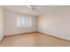 Bright bedroom showcasing a shuttered window, ceiling fan, and hardwood floors at 10520 W Coggins Dr, Sun City, AZ 85351