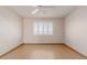 Empty bedroom featuring a shuttered window, ceiling fan, and hardwood floors at 10520 W Coggins Dr, Sun City, AZ 85351