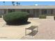 Charming single-story home featuring a landscaped front yard and a cozy bench for relaxing outdoors at 10520 W Coggins Dr, Sun City, AZ 85351