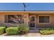 Inviting front entrance with security screen door and well-maintained landscaping at 10520 W Coggins Dr, Sun City, AZ 85351