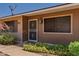 Inviting front entrance with security screen door and well-maintained landscaping at 10520 W Coggins Dr, Sun City, AZ 85351