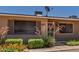 Inviting front entrance with security screen door and well-maintained landscaping at 10520 W Coggins Dr, Sun City, AZ 85351