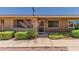 Inviting front entrance with security screen door and well-maintained landscaping at 10520 W Coggins Dr, Sun City, AZ 85351