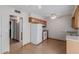Kitchen view featuring light hardwood floors, wood cabinets, and white appliances at 10520 W Coggins Dr, Sun City, AZ 85351