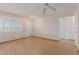 Bright living room featuring hardwood floors, ceiling fan, and a large window at 10520 W Coggins Dr, Sun City, AZ 85351
