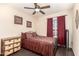 Comfortable bedroom with hardwood floors, ceiling fan, and large window with burgundy curtains at 10820 N 45Th Dr, Glendale, AZ 85304