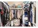 Walk-in closet with an array of clothing, built-in shelves, and overhead storage providing an organized space at 10820 N 45Th Dr, Glendale, AZ 85304