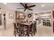 Spacious dining area with a view of the kitchen, a brick fireplace, and tile flooring at 10820 N 45Th Dr, Glendale, AZ 85304