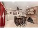Well-lit dining room features tile floors, a brick fireplace, and seating for six at 10820 N 45Th Dr, Glendale, AZ 85304