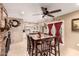 Open-concept dining area features a brick fireplace, tile flooring, and a view into the bright kitchen at 10820 N 45Th Dr, Glendale, AZ 85304