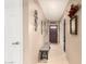 Inviting entryway featuring neutral-toned walls, tiled floor, and a charming wooden bench at 10820 N 45Th Dr, Glendale, AZ 85304