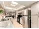 Bright eat-in kitchen with tile floor, updated appliances, and lots of natural light from the overhead skylight at 10820 N 45Th Dr, Glendale, AZ 85304
