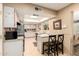 Bright kitchen features a sky light, a pass-through to the living room, and a breakfast bar at 10820 N 45Th Dr, Glendale, AZ 85304