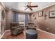 This living room has wood floors, recliners, soft window lighting, and tasteful wall decorations at 10820 N 45Th Dr, Glendale, AZ 85304
