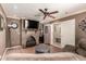 The comfortable living room features a fireplace, and a ceiling fan, with extra room for an office space at 10820 N 45Th Dr, Glendale, AZ 85304