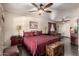 Large main bedroom with ceiling fans, dark hardwood floors, and a relaxing seating area at 10820 N 45Th Dr, Glendale, AZ 85304