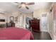 Primary bedroom featuring hardwood floors, ceiling fan, walk-in closet, ensuite bathroom, and a cozy fireplace at 10820 N 45Th Dr, Glendale, AZ 85304