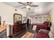 Bright main bedroom with hardwood floors, ceiling fans, a fireplace, and lots of space for relaxing at 10820 N 45Th Dr, Glendale, AZ 85304
