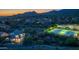 Aerial view of the community showcases lush landscaping, a pool, tennis courts and mountain views at 11089 N 130Th Pl, Scottsdale, AZ 85259