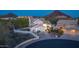 Aerial view reveals lush landscaping, a three-car garage, and desert mountain views at 11089 N 130Th Pl, Scottsdale, AZ 85259