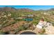 Expansive aerial view of desert home featuring lush desert landscape, community tennis courts, and mountain views at 11089 N 130Th Pl, Scottsdale, AZ 85259