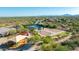 High-angle aerial view of community park featuring a covered playground, tennis courts, and a basketball court at 11089 N 130Th Pl, Scottsdale, AZ 85259