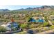 Aerial view of home featuring lush backyard landscape, pool, mountains, community tennis courts and desert landscape at 11089 N 130Th Pl, Scottsdale, AZ 85259