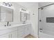Stylish bathroom with dual sinks, modern fixtures, and a beautifully tiled shower/tub combo at 11089 N 130Th Pl, Scottsdale, AZ 85259