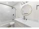Bathroom featuring a marble countertop, black hardware, and a shower with marble surround at 11089 N 130Th Pl, Scottsdale, AZ 85259
