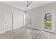 Bedroom with sliding closet doors, a ceiling fan, and an exterior door to the backyard at 11089 N 130Th Pl, Scottsdale, AZ 85259