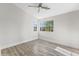 Light filled bedroom with wood-look flooring and large windows at 11089 N 130Th Pl, Scottsdale, AZ 85259