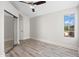 Bright bedroom with wood-look floors, ceiling fan and large window views at 11089 N 130Th Pl, Scottsdale, AZ 85259