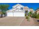 Home with three-car garage, desert landscaping and mature trees at 11089 N 130Th Pl, Scottsdale, AZ 85259