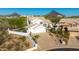 Two-story home showcasing a three-car garage, driveway, and desert landscaping at 11089 N 130Th Pl, Scottsdale, AZ 85259