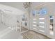 Bright foyer with large windows, chandelier and staircase creates a welcoming entry at 11089 N 130Th Pl, Scottsdale, AZ 85259